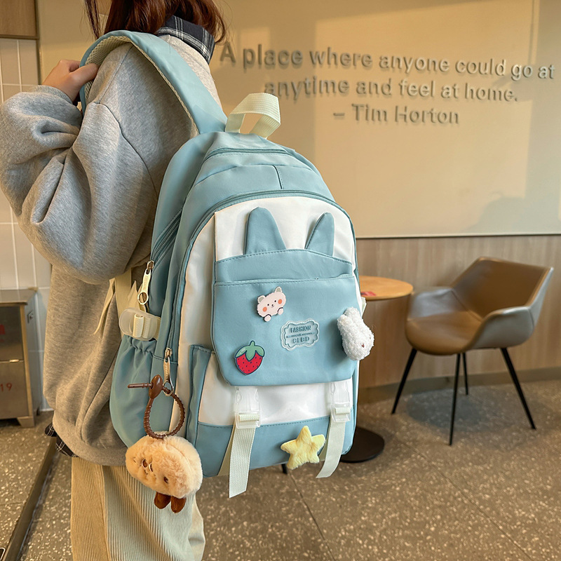 La versión coreana de las mochilas escolares de doble hombro está llena de mochilas escolares de primaria y mochilas escolares de tendencia de la escuela secundaria de gran capacidad.