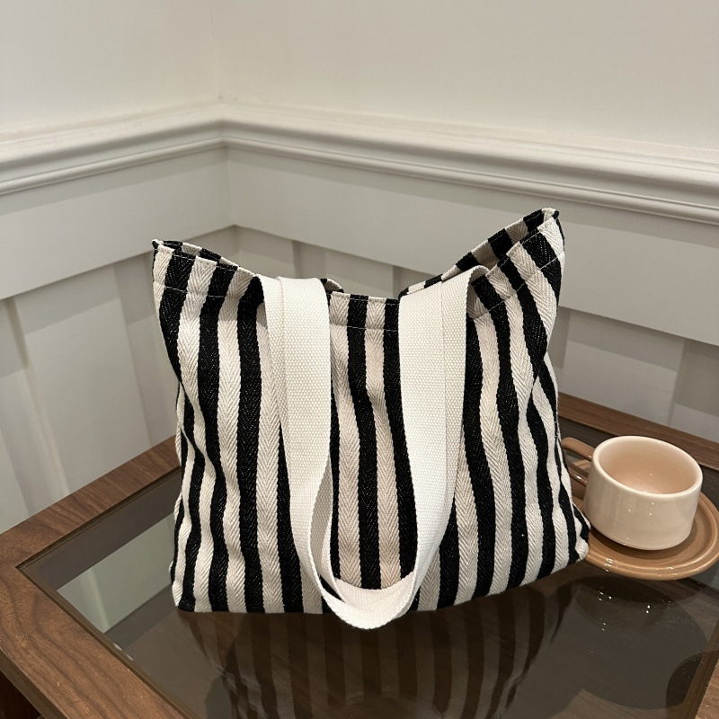 The new cross-border vertical striped commuter tote bag, hand-held shoulder bag, is fashionable and has a large capacity. It features an InS-style simple letter sail undefined