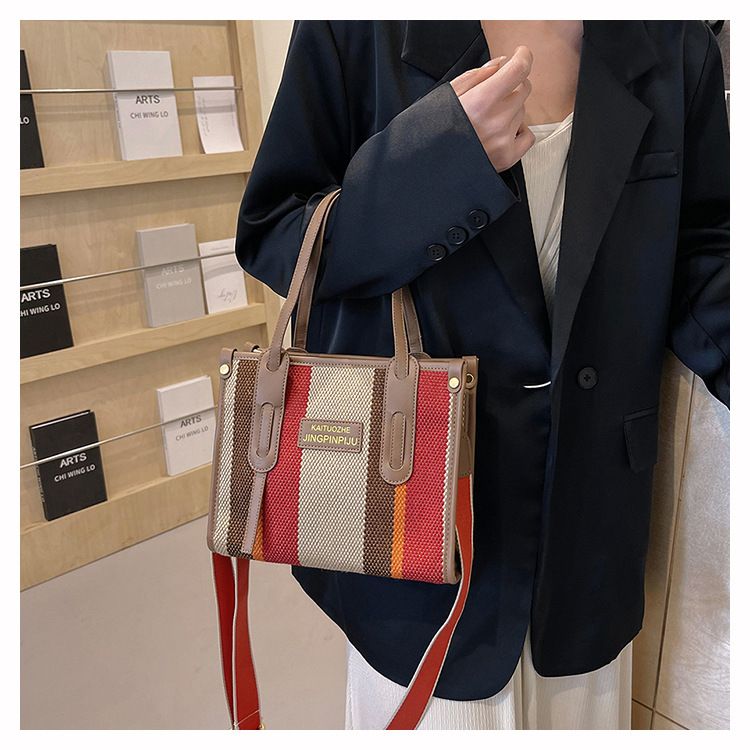 Bolso Tote portátil a rayas de color de contraste de lona para mujer 2024 nueva textura de moda transfronteriza bolso de mensajero de un solo hombro