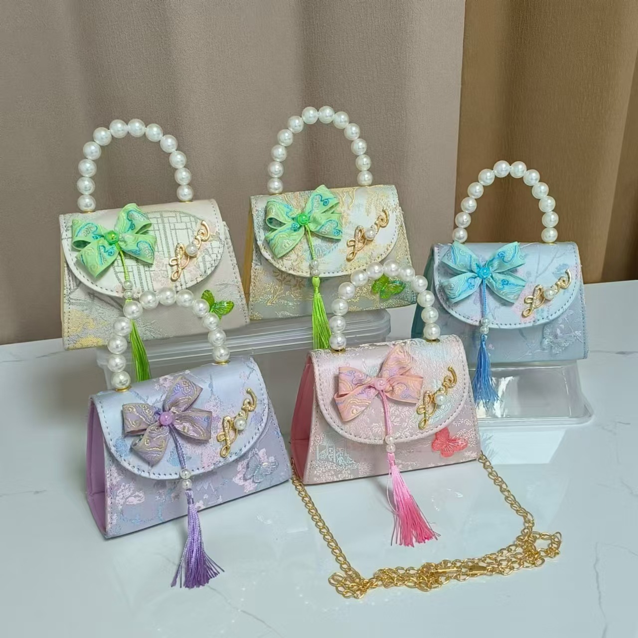 Bolsas de niños arco de estilo chino borda de niña pequeña princesa perla bolsa de cambio de mano al por mayor