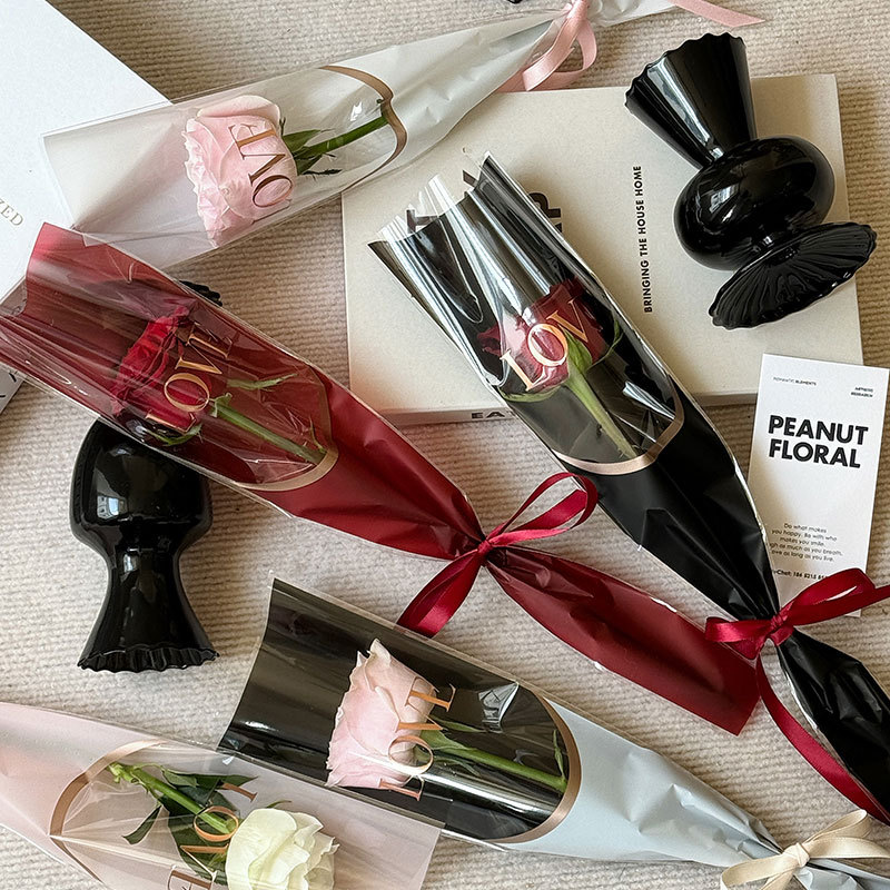 Huaxi LOVE estampado bolsas de flores bolsas de flores rosa bolsas de vidrio transparente papel de embalaje de flores OPP