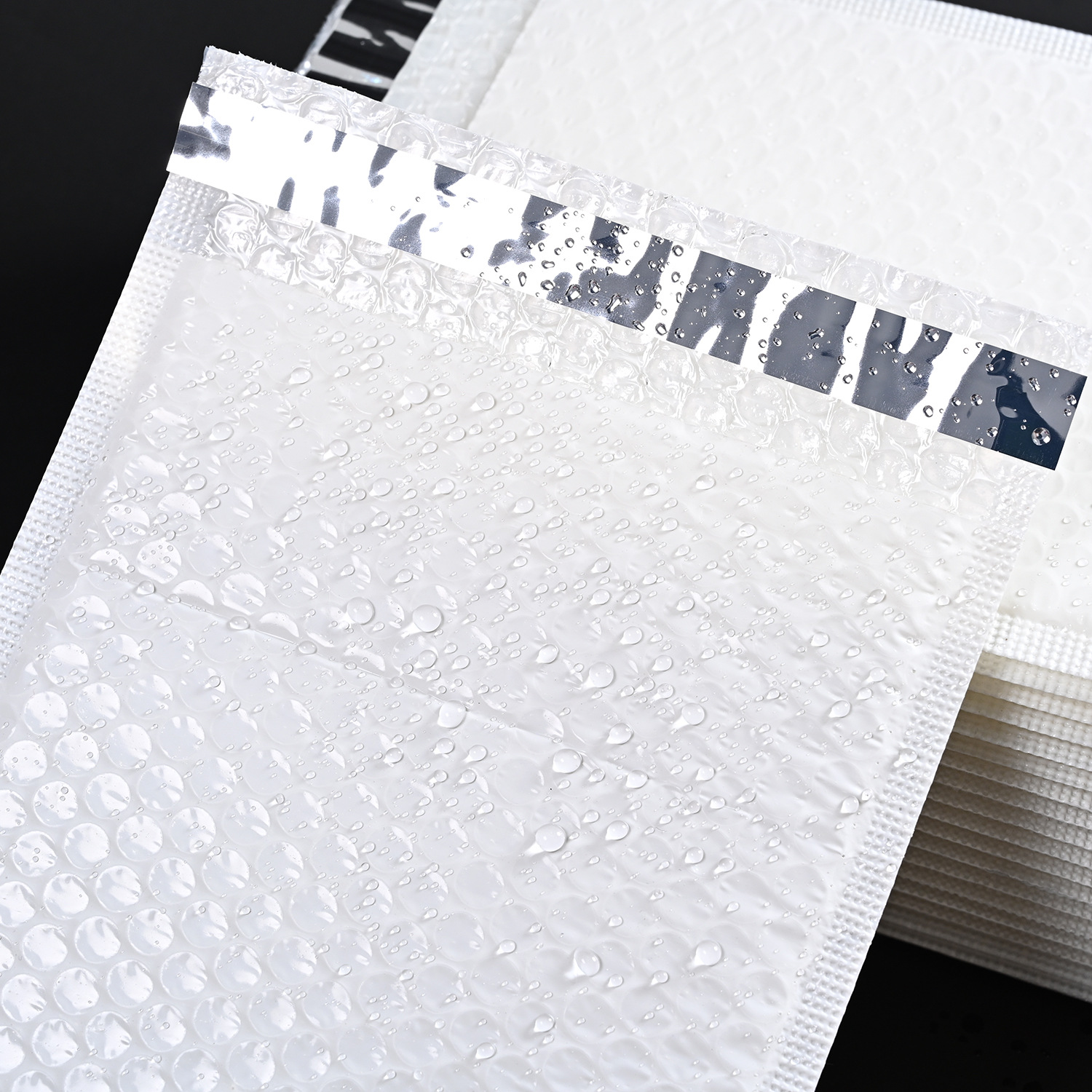 Bolsa de burbuja de ropa de película blanca lechosa bolsa de espuma bolsa de embalaje de tira de envoltura de película de perla a prueba de golpes impermeable al por mayor