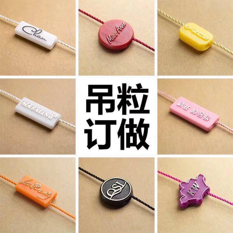 吊粒工厂定 制高档双插LOGO刻字烫金圆柱体吊粒服装吊牌挂绳吊粒-阿里巴巴