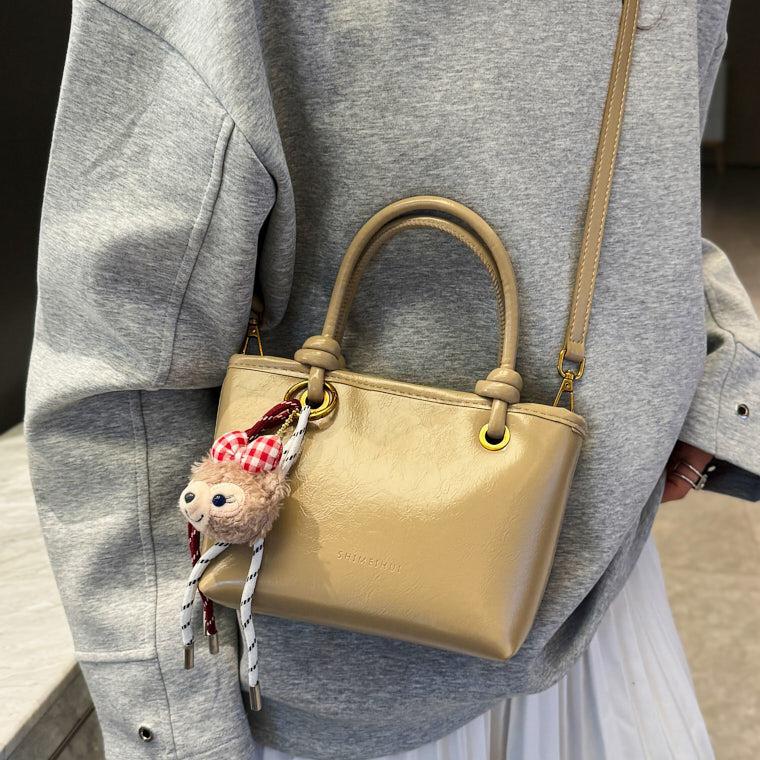 Super caliente versátil bolso de cubo portátil 2025 nuevo popular simple mochila de hombro en línea tendencia explosiva bolso de mujer