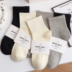 Black and white socks for women in autumn and winter cotton high elastic mid-calf socks for women solid color ins trendy casual sports socks wholesale