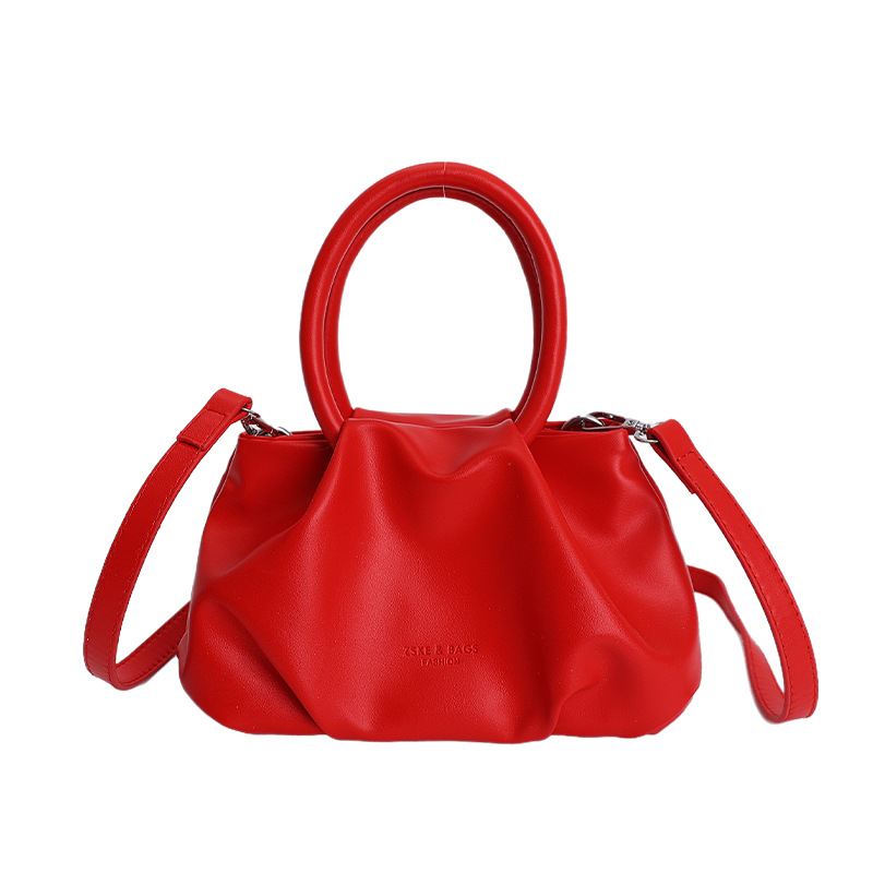 Alta sensación de mano pliegueada nube bolso de cubo para mujeres 2026 nuevo nicho de lujo ligero de moda perla bolsa de mochila