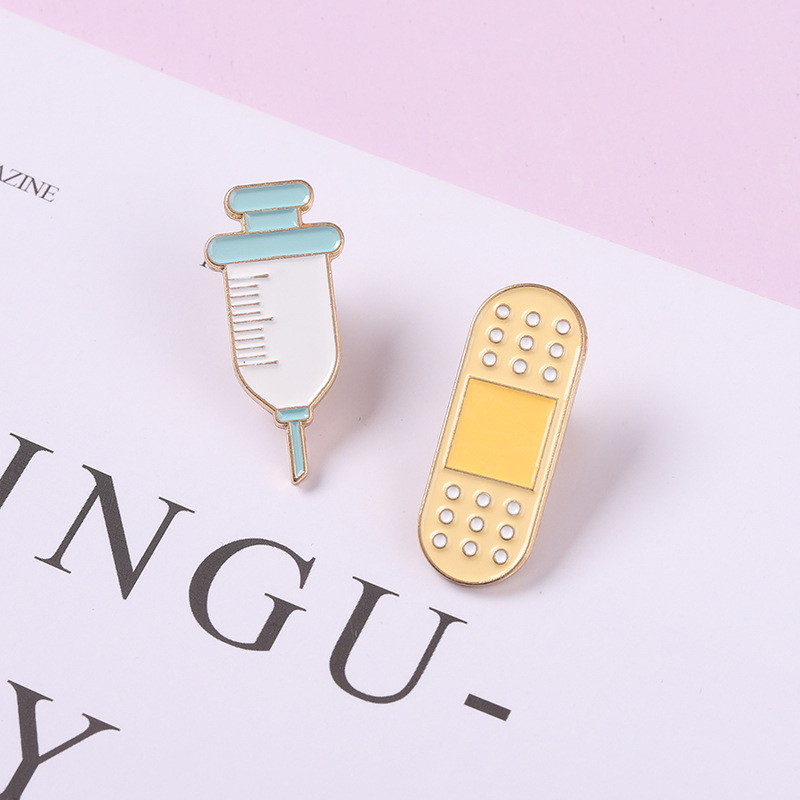 AliExpress new medical alloy brooch personalized needle and Band-Aid shape paint badge clothing accessories
