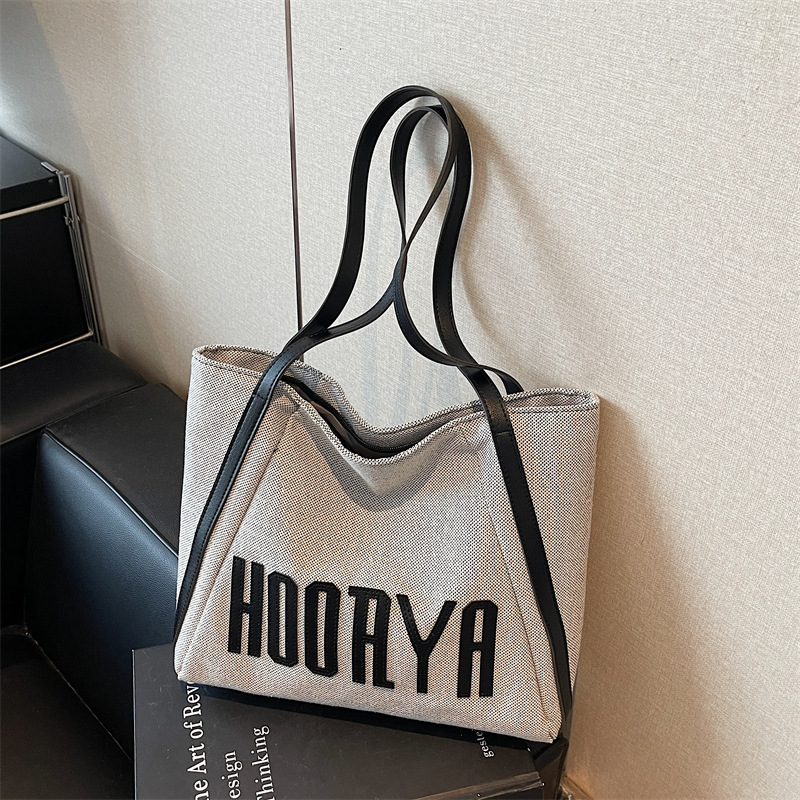 Bolsa de lona de gran capacidad para viajes 2025 nueva bolsa de mujer bolsa de hombro casual estilo exterior versátil bolso universitario
