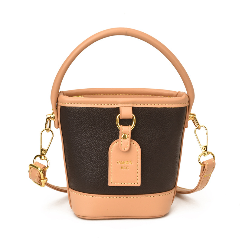 Mini pequeño bolso de cubo de mano para niños 2026 nuevo estilo de alta calidad de moda versátil bolso de mochila de estilo exterior