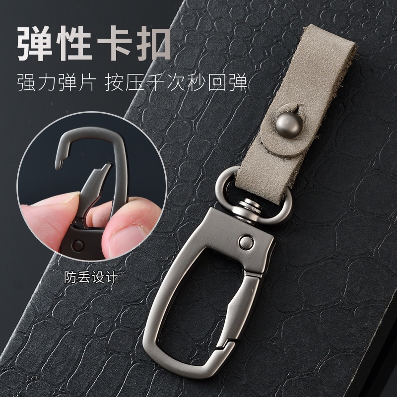 軽くて豪華な本革の自動車のキーホルダーの頭の層のつや消しの牛革の車のキーチェーンの個性のカップルの腰は掛けてペンダントをなくします。