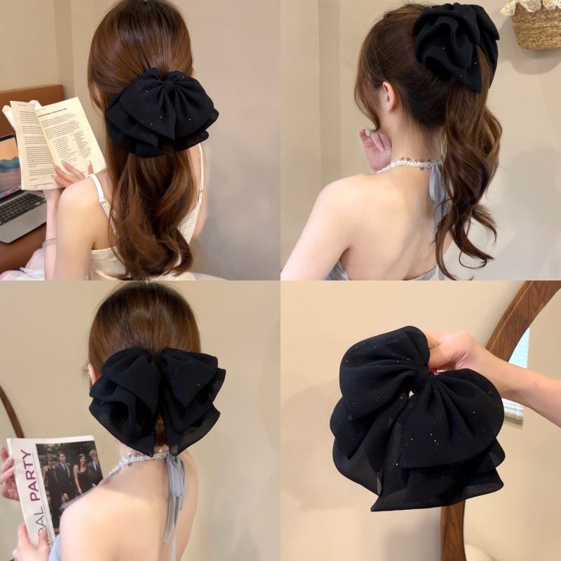 Elegant black crab pin with bow
