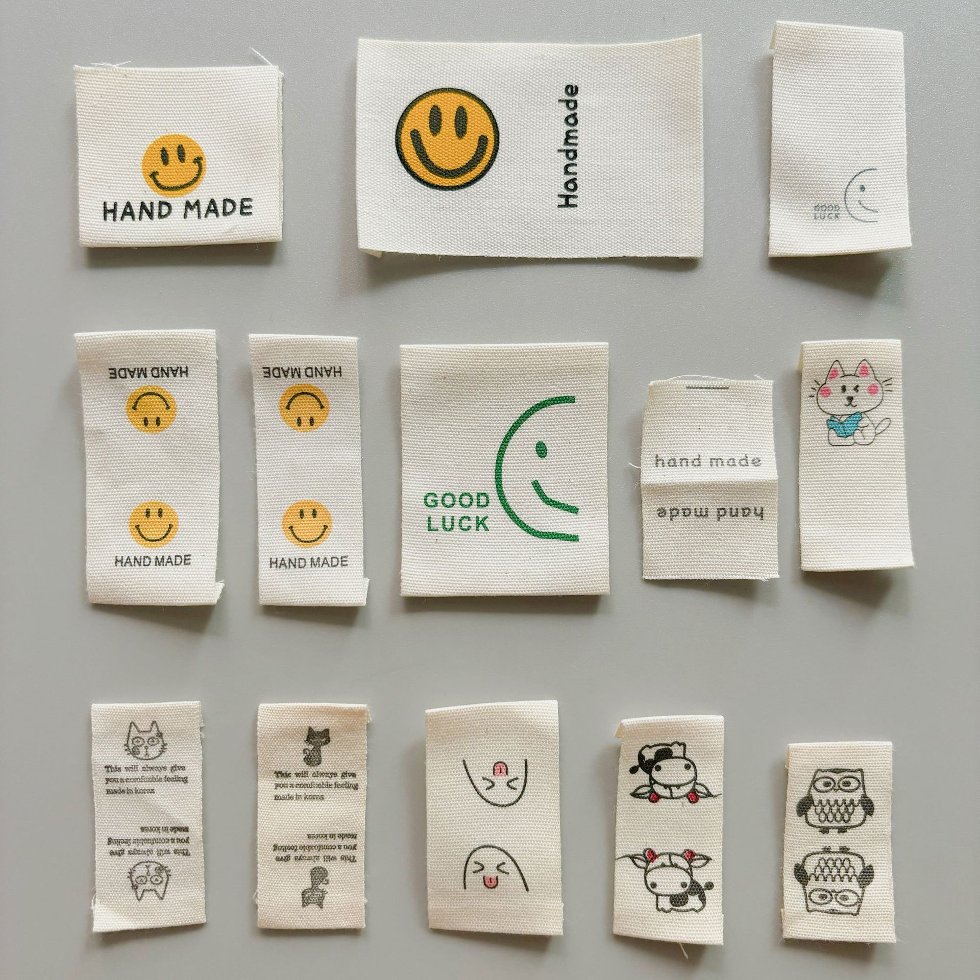 재고 목화 수제 인쇄 마크 헴 사이드 라벨 웃는 얼굴 새끼 고양이 천 라벨 의류 가방 양말 액세서리 액세서리