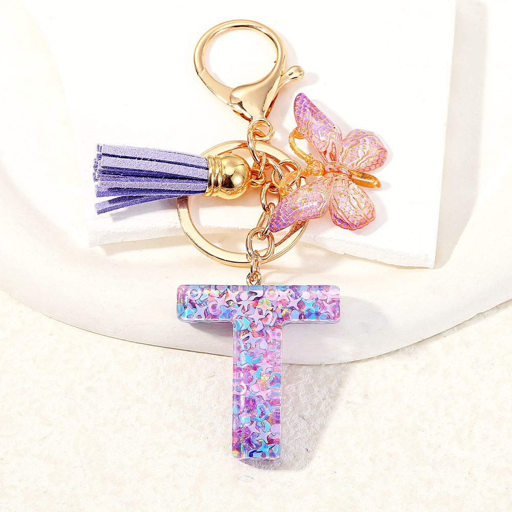 Mayorista transfronterizo mariposa esquinilla iniciales llavero de cristal goteo llavero de letras bolsos colgante
