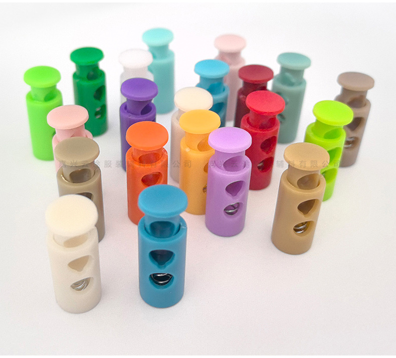 Kunststoff-Farbfedern-Schnallenverschluss, zweilöchrige zylindrische Seilschnalle, Daunenjacken-Verstellschnalle, Elastic-Stopper, Rutschfester Verschluss, Glockenform-Schnalle