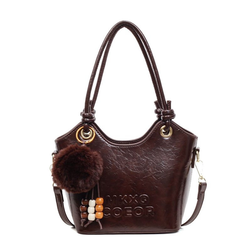 Retro alta sensación de bolso de cubo de mano 2025 invierno nuevo ocio versátil bolso de hombro de viaje mochila de mujer