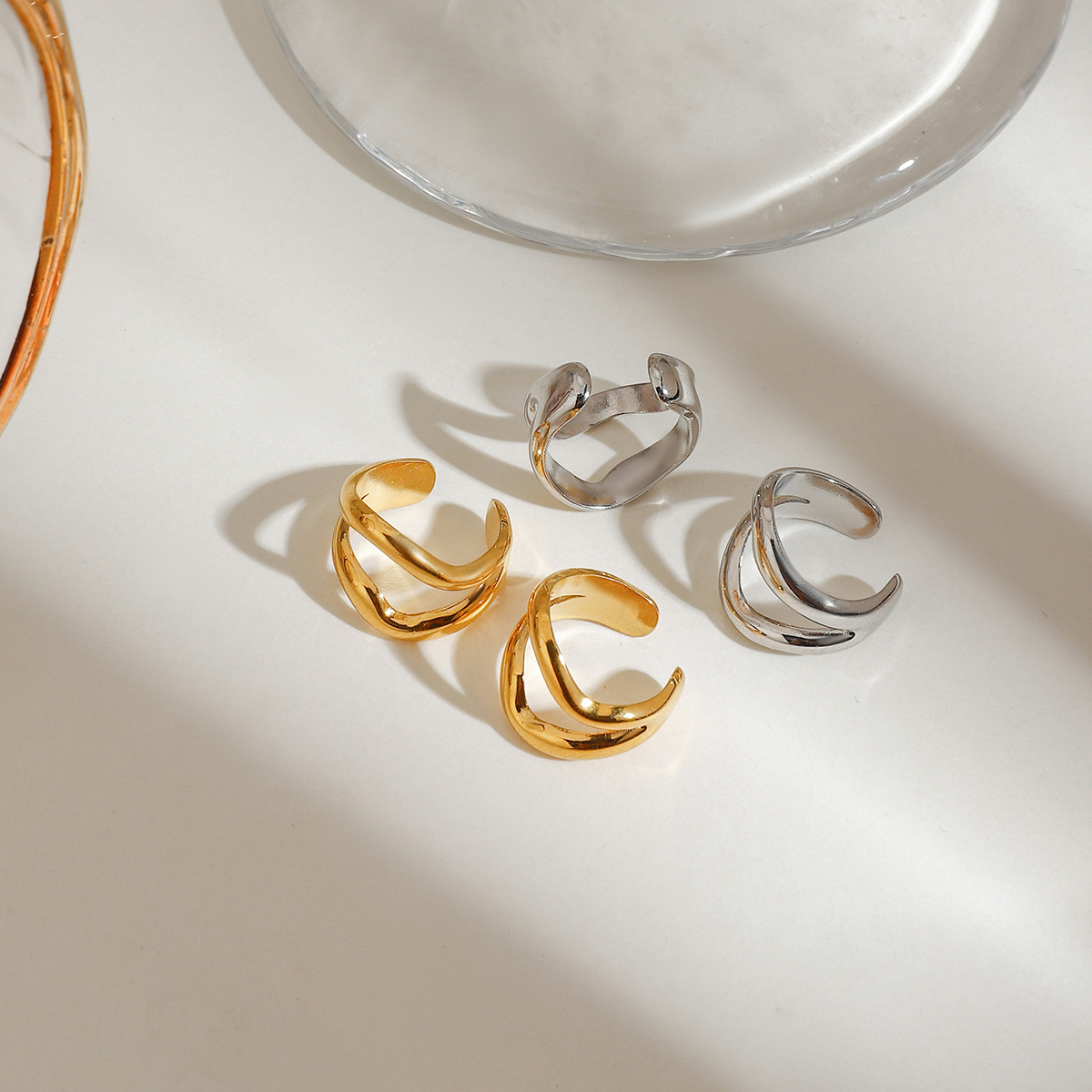 Wanxing Europa y América moderna galvanoplastia minimalista línea simple auriculares huecos de acero inoxidable transfronterizo versátil no se desvanece auriculares