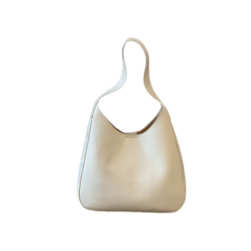 Nicho de diseño simple bolso de cubo portátil para mujeres 2026 primavera nueva moda perezosa retro bolso de brazo diario