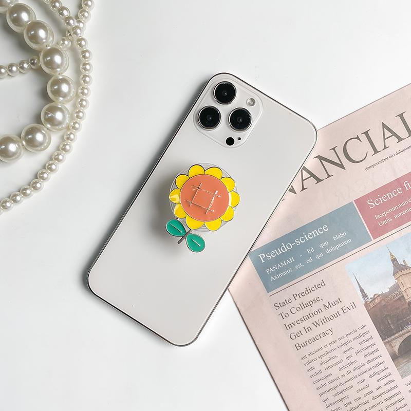 Instagram phone airbag with electroplated four leaf clover alloy sunflower desktop lazy support bracket on the back_voghion.com