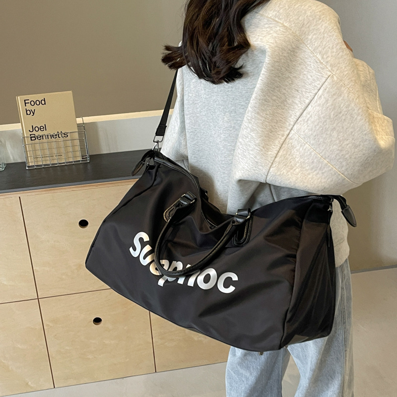 Bolso de viaje de corta distancia de gran capacidad de sensación de alta calidad Bolso de equipaje de almacenamiento portátil impreso de moda Bolso de gimnasio de mensajero de hombro para mujer