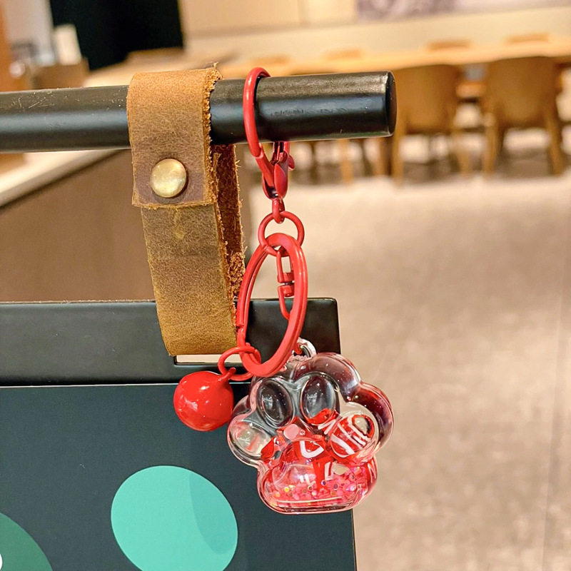 Caricatura en aceite líquido arena flotante botella mochila llavero delicado colgante accesorios accesorios máquina de muñecas pequeños regalos al por mayor