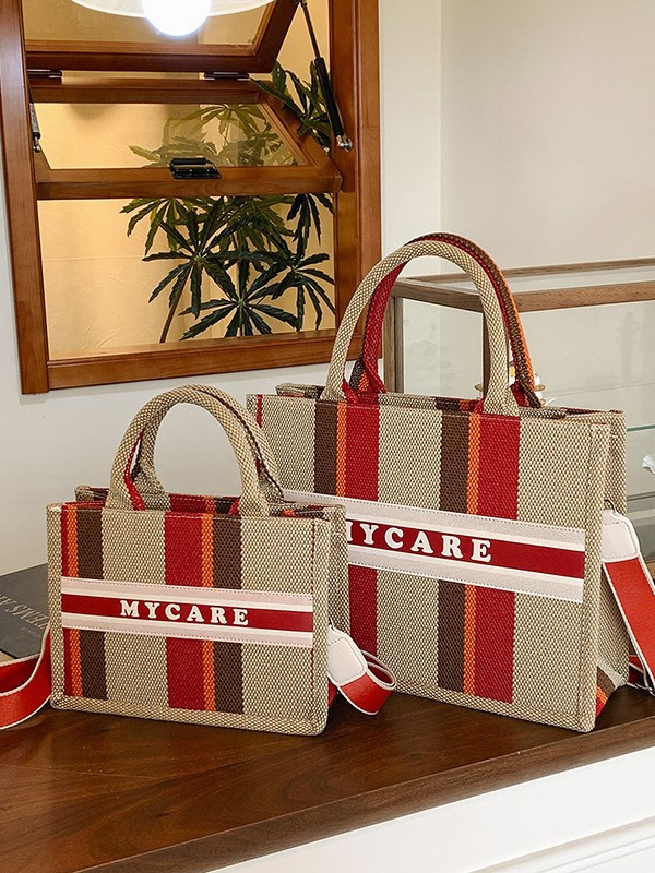 Bolso portátil de alta gama a rayas con sentido al por mayor transfronterizo logotipo personalizado nuevo casual todo-fósforo bolso de mensajero de gran capacidad
