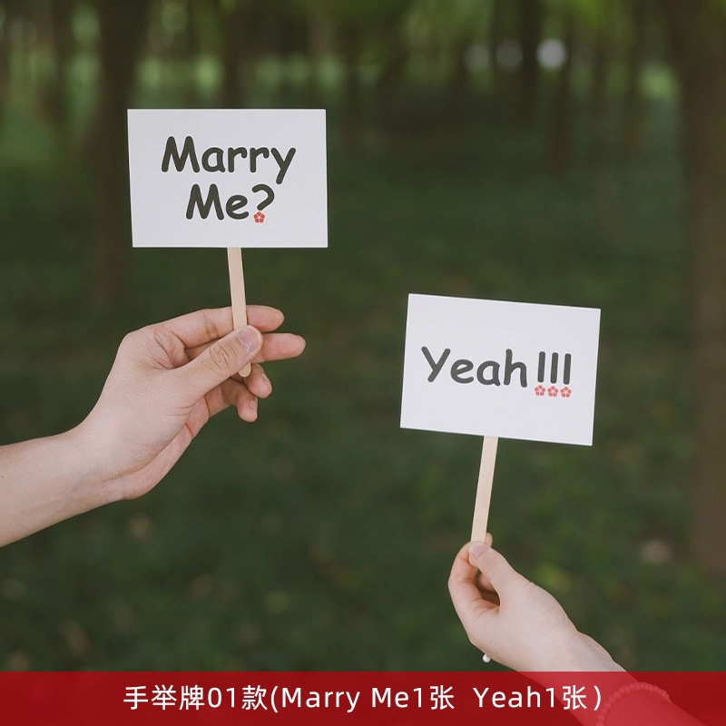 [white] take photos with a sign in hand, 1 pair