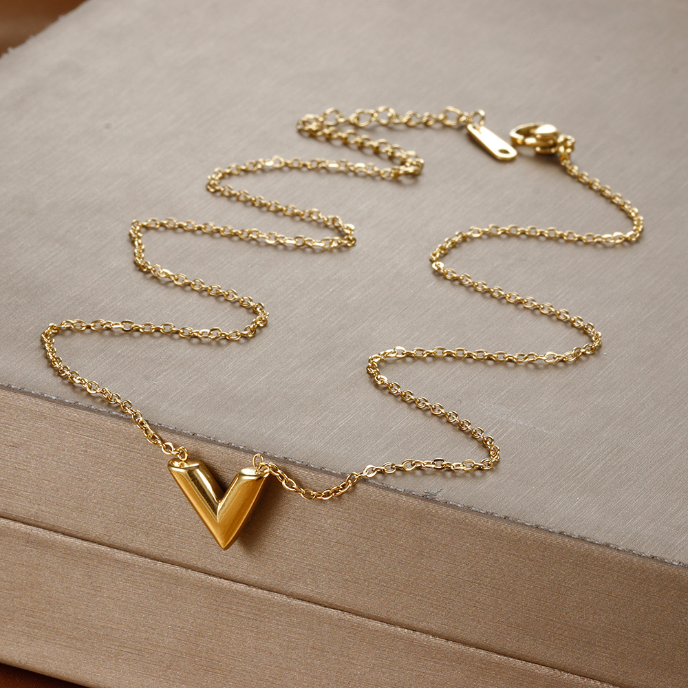 Golden necklace with letters