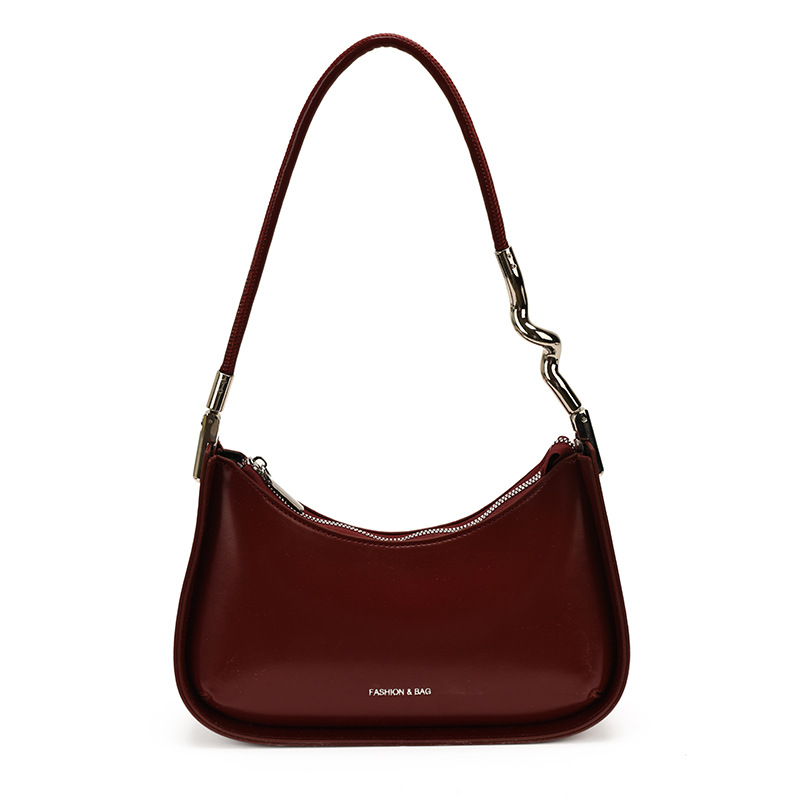Nicho de diseño bolso de brazo para mujeres 2026 comercio exterior nueva moda alta sensación de viaje simple bolso de media luna de hombro