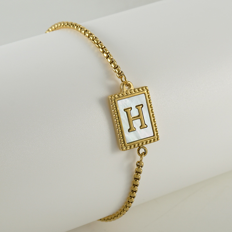 Nuevo europeo y americano transfronterizo de acero inoxidable 26 letras inglesas Shell pulsera personalidad todo partido titanio acero 18K cremallera