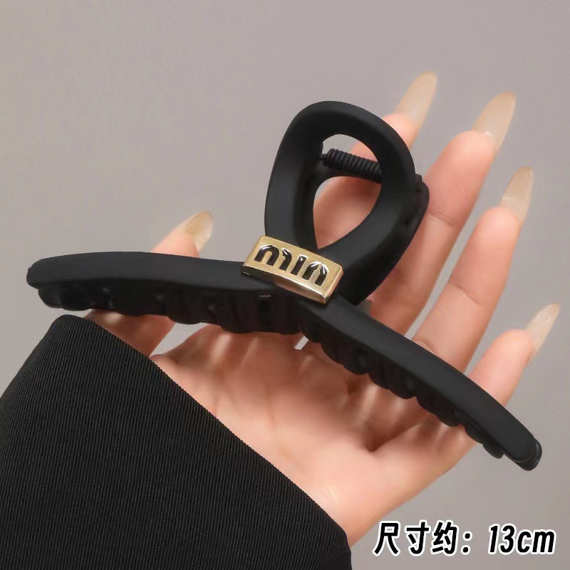 Black crab pin with letters
