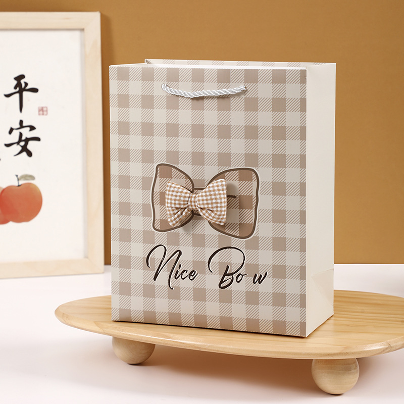 Personalidad de arco de papilla espesa bolsa de regalo de papel blanco regalo de cumpleaños bolsa de papel de embalaje de regalo de fábrica directa
