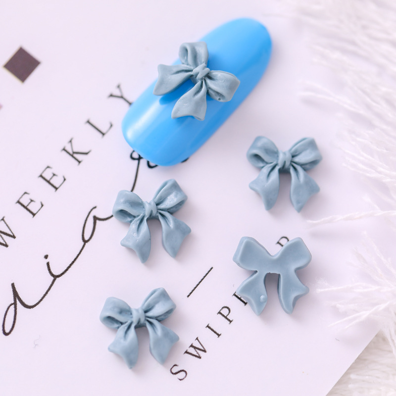 Mariposa de uñas popular repujado arco resina pajarita joyería simple todo partido tridimensional hueco decorativo diamante