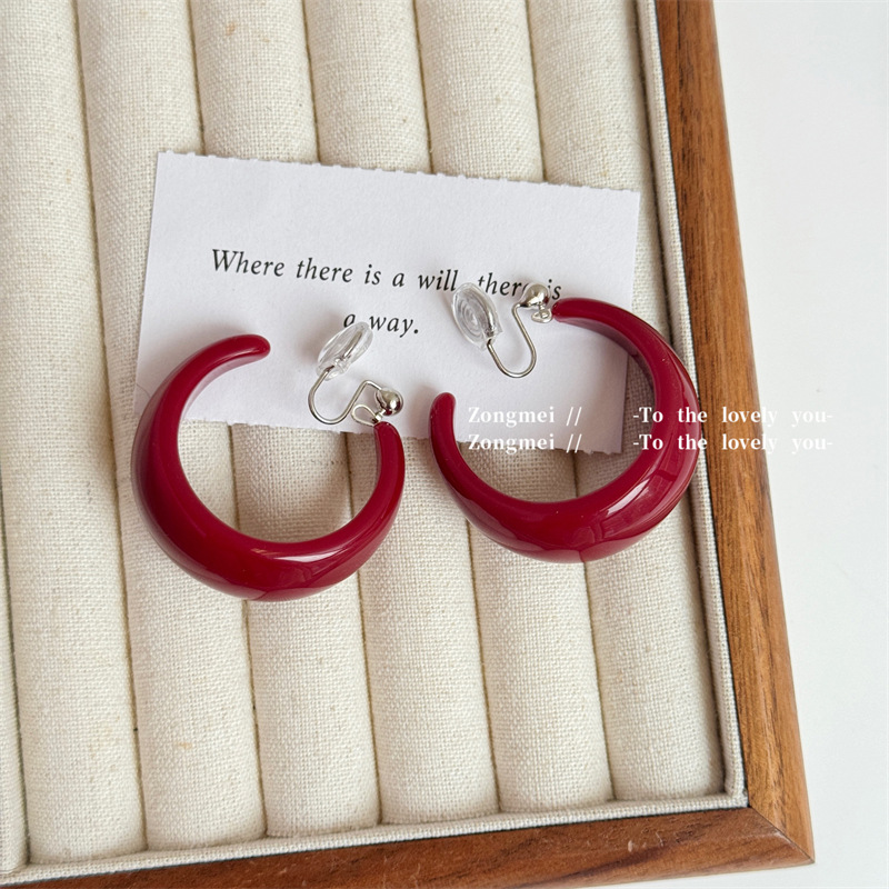 A pair of burgundy mosquito coil trays