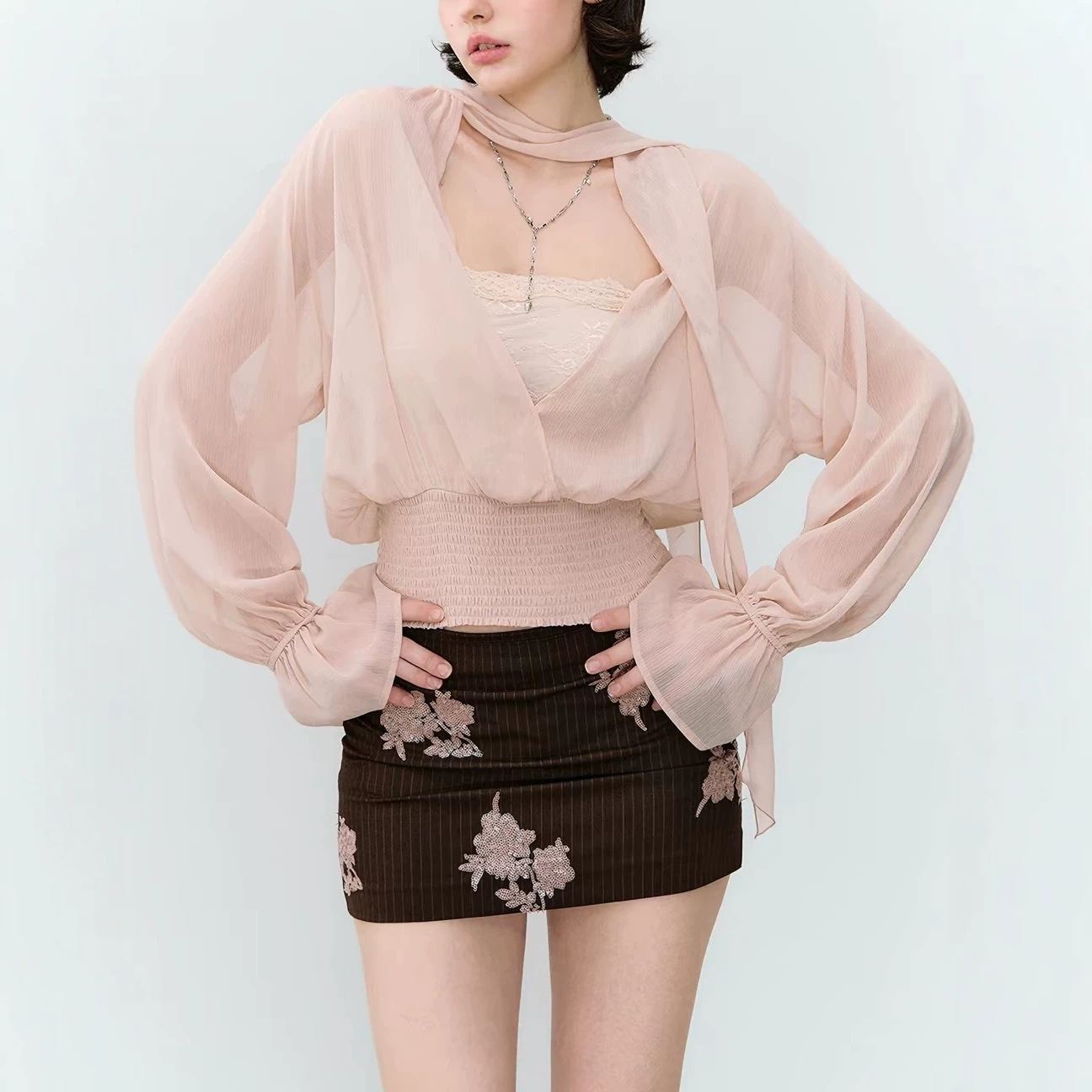 Dual-sided persona, a relaxed style reversible chiffon blouse with a flowing collar, pleated waist, and slightly sheer design.