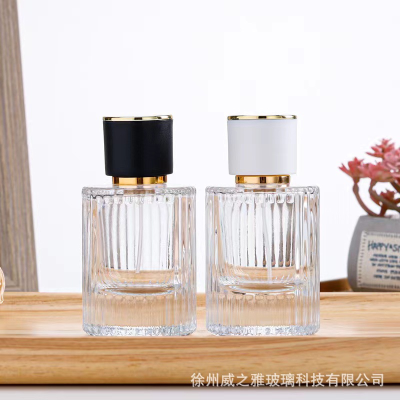 Venta al por mayor 30ml botella de dispensación de perfume cilíndrico 50ml botella de dispensación de loción de rayas verticales botella de rociador de presión botella de perfume