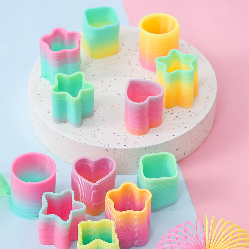Fábrica directa pequeña mágica arco iris círculo de estudiantes juguetes de puzzle mini bobina de forma extraña mercado nocturno tienda de suministro