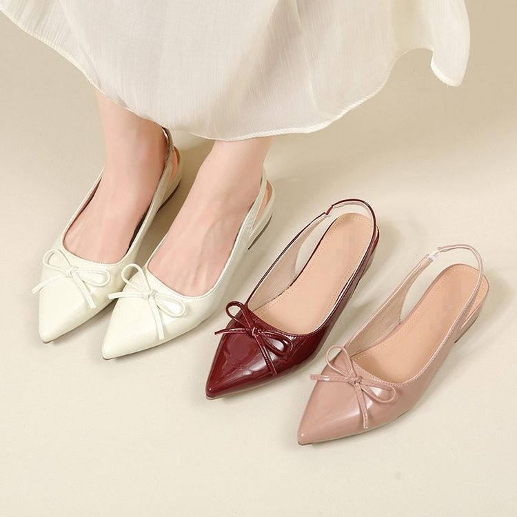 Zapatos de tacones planos transpirables para mujeres verano 2026 nuevo arco de estilo francés detrás de zapatos vacíos sandalias de punta para mujeres
