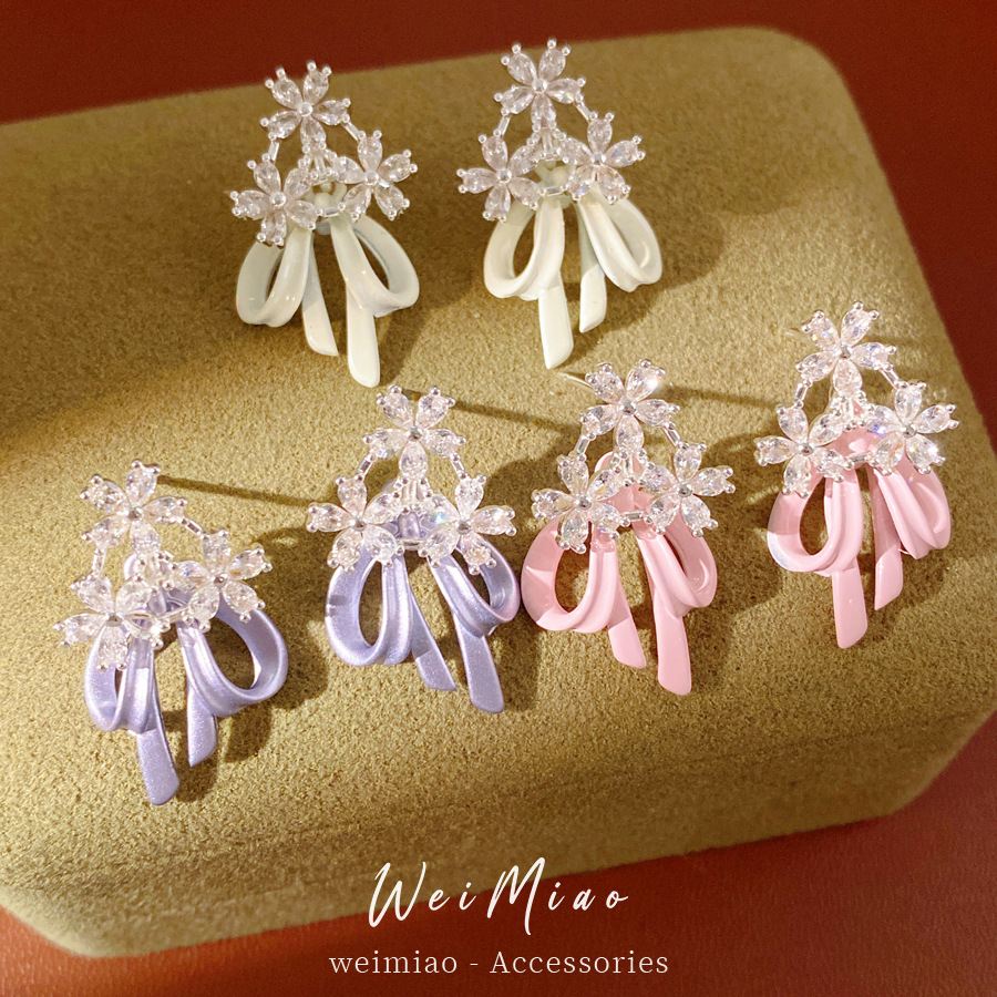 Aguja de plata goteando aceite de zircon flores arco pernos temperamento moda aretes dulces ligero lujo alta sensación de auriculares al por mayor