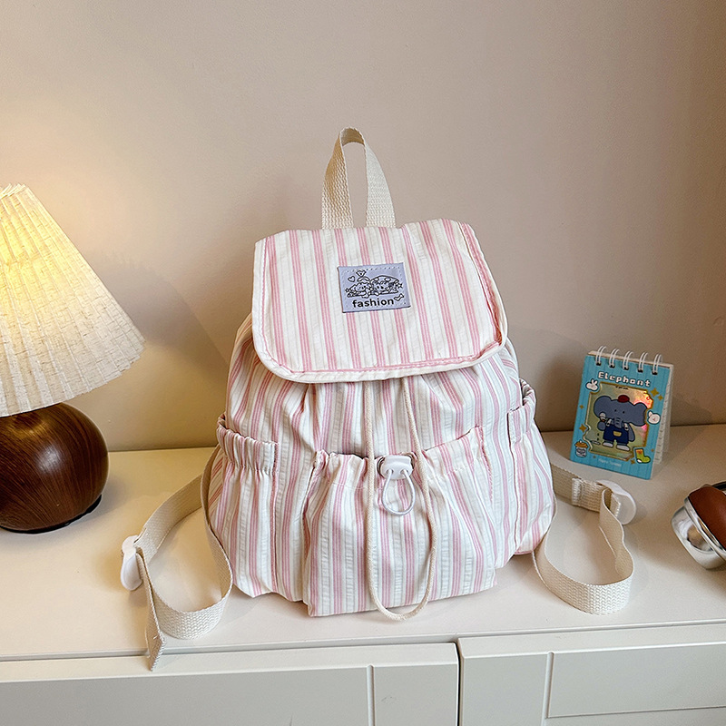 Bolsa de lona a rayas casuales de viento universitario para mujeres verano 2026 nueva mochila simple de gran capacidad mochila de estudiantes