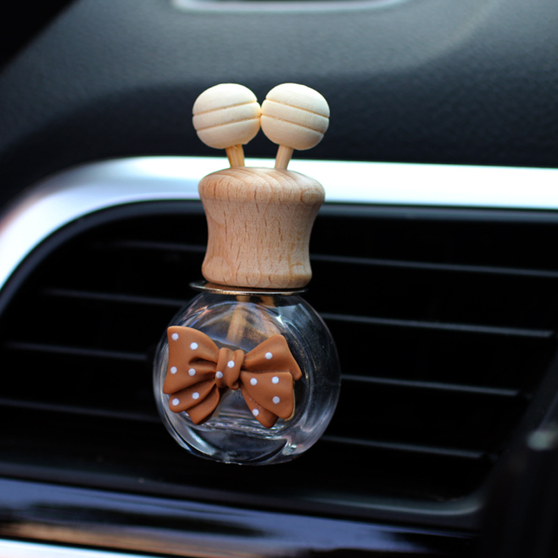 Salida de aire de perfume de coche, dibujos animados, celebridad de Internet, botella de aromaterapia de coche, clip de aire acondicionado, accesorios de coche, bowknot tembloroso