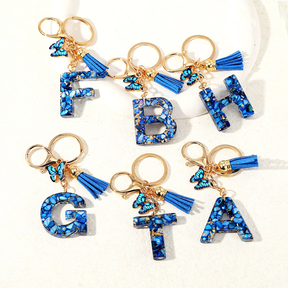 Nuevo transfronterizo mariposa 26 letras inglesas de cristal goteo llavero bolsos accesorios colgante de automóviles
