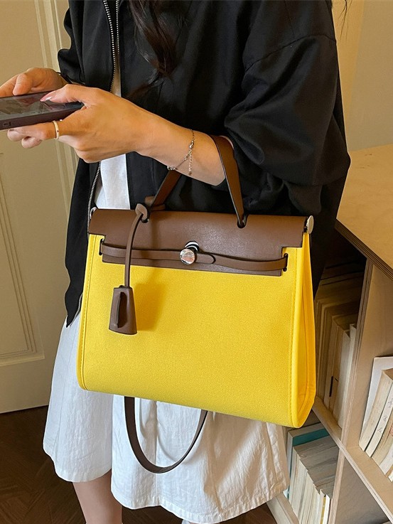 Nicho de moda portátil Kelly bolso mujer 2026 nuevo cross-border lienzo empalme color contraste viaje mochila de hombro