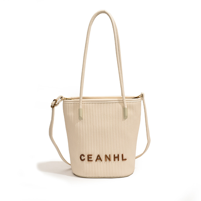 2025 otoño y invierno nuevo pequeño bolso a rayas de viento fragante bolso de cubo simple bolso de hombro de tendencia de mujeres bolso de mochila popular