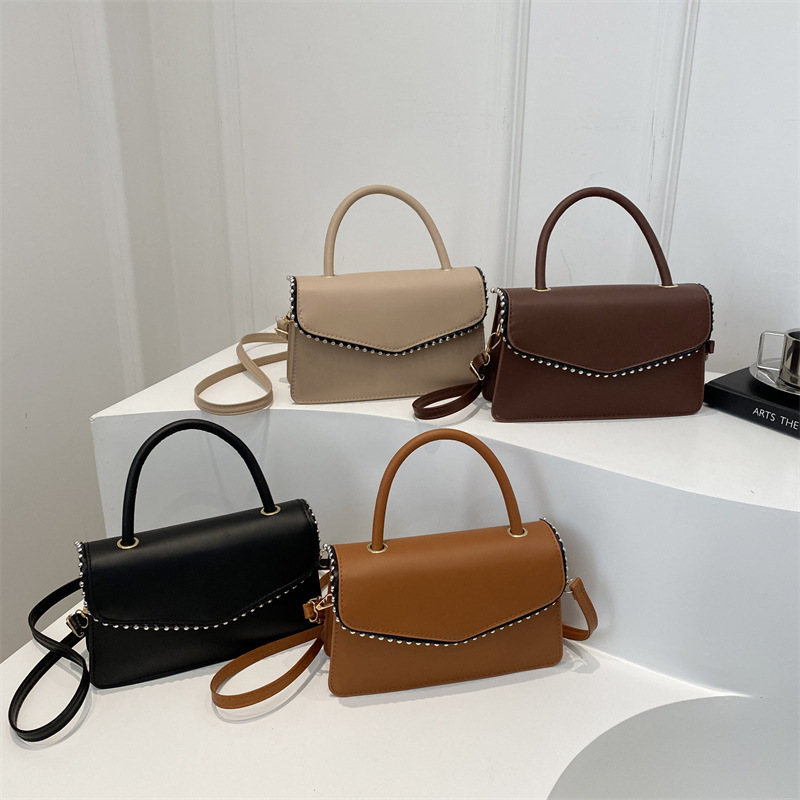 Bolso de hombro de aire extranjero para mujeres 2025 primavera nueva moda coreana portátil de color sólido simple bolso de tendencia