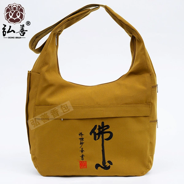 Earthy yellow and black Buddha heart style canvas crescent bag