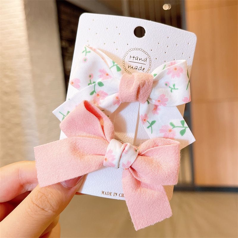 Clip de arco para niños primavera y verano nuevo clip de pico de pato fresco traje estudiante flequillos clip horquilla del corazón de la niña