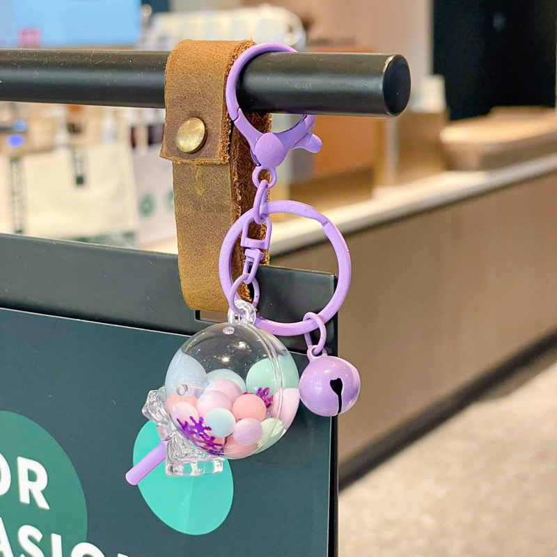 Caricatura en aceite líquido arena flotante botella mochila llavero delicado colgante accesorios accesorios máquina de muñecas pequeños regalos al por mayor