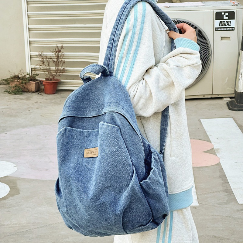 Mochila de mezclilla de gran capacidad para estudiantes de secundaria para mujeres, bolsa de viaje ligera, mochila de ocio estilo de Hong Kong, mochila al por mayor