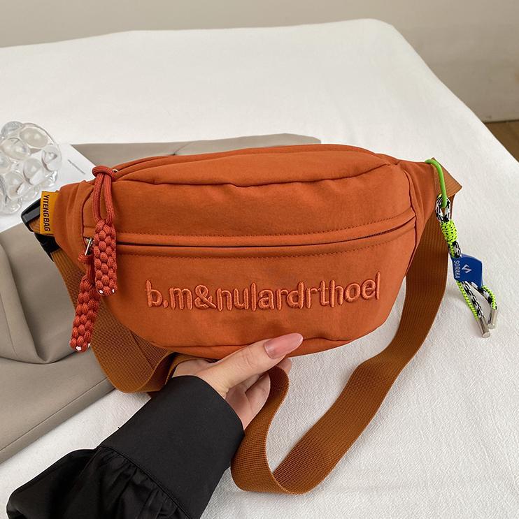 Bolsa de lona para mujeres 2025, nuevo estilo coreano de bolso de mochila deportiva casual popular, bolso de pecho de fuego, bolso de cintura de alta calidad