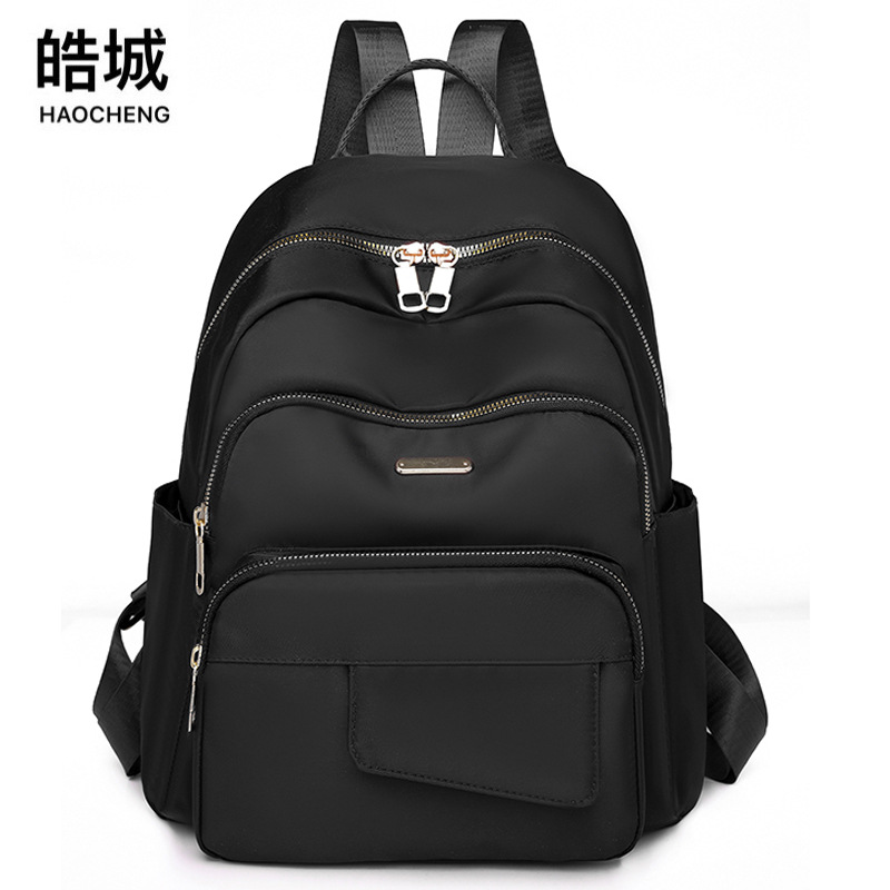 2024 nueva mochila casual de nailon de color sólido para mujer, mochila de viaje de gran capacidad para viajes al aire libre simple y de moda